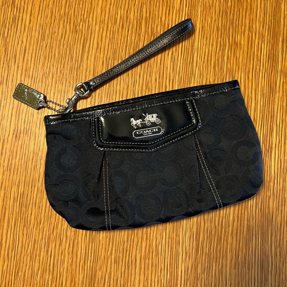 Black Coach clutch with zipper and one inside pocket.